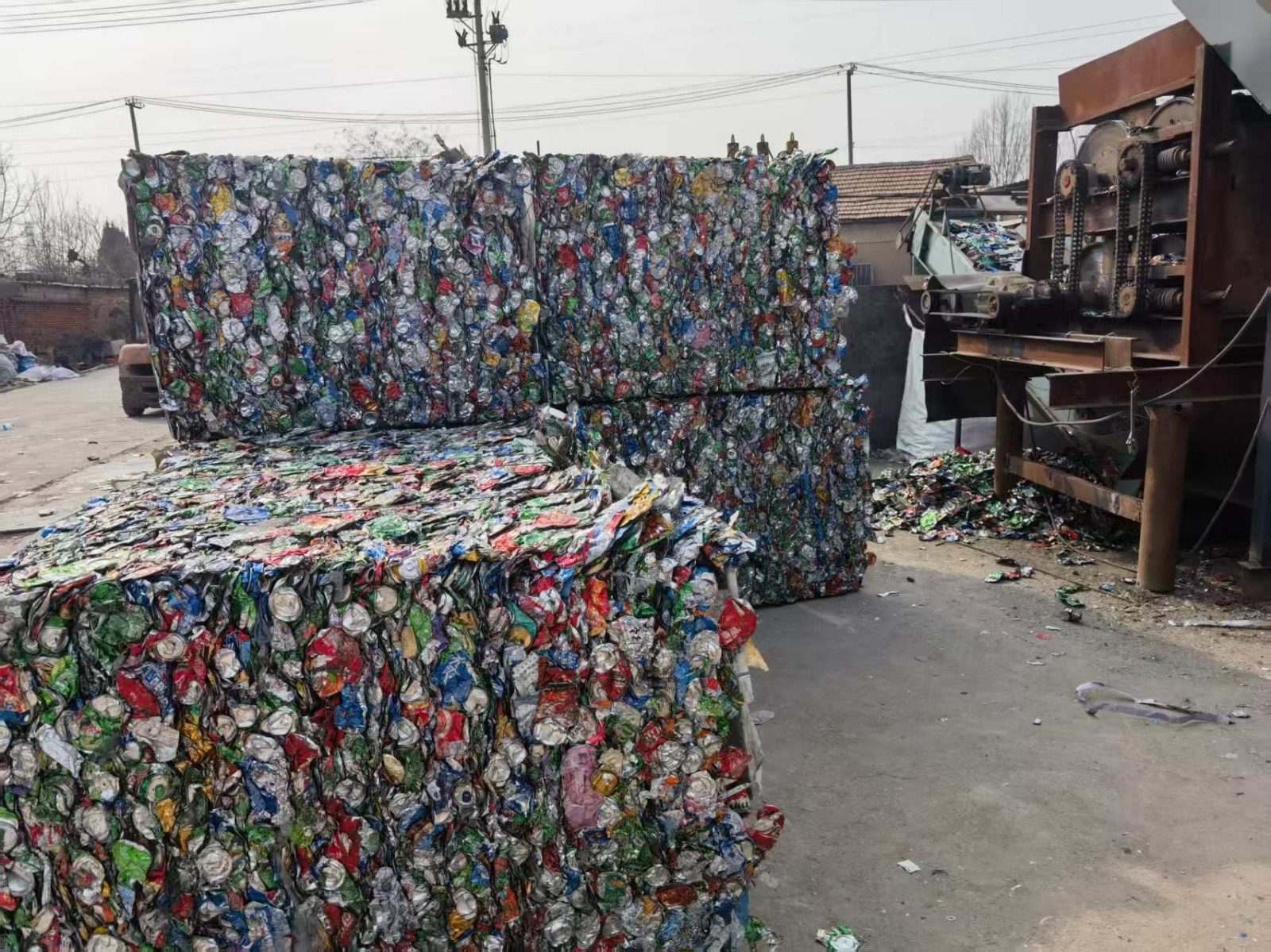 Compressed used beverage can scrap bales in a processing yard