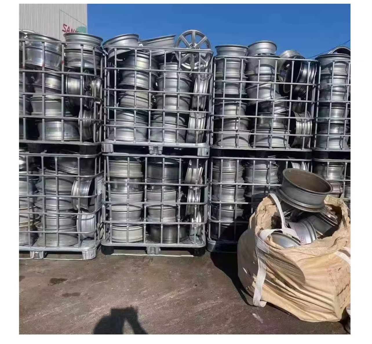 Aluminium wheel scrap stored in metal cages